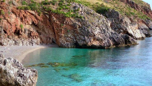 Paradise beach and turquoise sea at "Cala Capreria" into natural reserve “Riserva dello Zingaro”, Scopello, Sicily, Mediterranean Sea, Italy.
