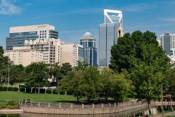 Obraz na płótnie Canvas The Charlotte, NC skyline viewed from Marshall Park on a blue sky day in the summer