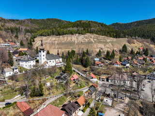 Aerial view of the church in the village of Spania Dolina in Slovakia - obrazy, fototapety, plakaty