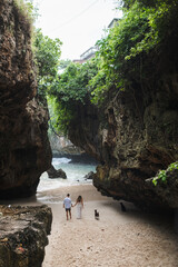 Сouple in love walking on the beach, uluwatu, Bali.