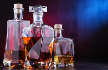 Obraz na płótnie Canvas Carafe and bottles of assorted alcoholic beverages