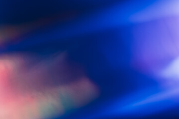 Defocused light leak. Bokeh neon glow. Sci-Fi radiance. Blur fluorescent navy blue orange purple color flecks flare motion on dark futuristic abstract background.