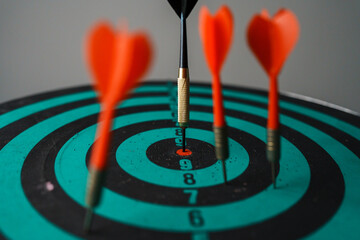 Bullseye is a target of business. Dart is an opportunity and Dartboard is the target and goal. So both of that represent a challenge in business marketing as concept.	
