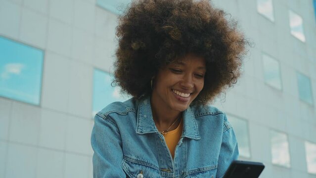 Beautiful young woman with curly hair having fun and doing activities outdoor in Paris. Concept about people and lifestyle