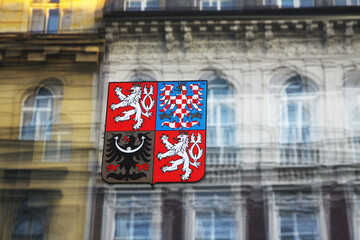 Naklejka premium Coat of arms of the Czech Republic on the glass and historical buildings are reflected
