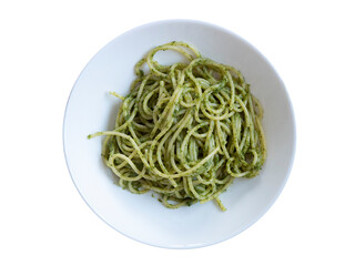 Plate of pasta, spaghetti with Genovese pesto, isolated on white background. Spaghetti with basil pesto, cut out. Mediterranean diet, Italian recipe green sauce food.