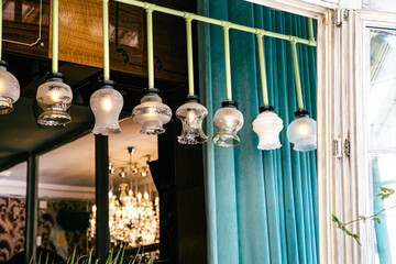 Antique vintage chandeliers with lamps inside, retro exterior detail.