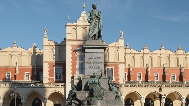 Statue of Adam Mickiewicz and Sukiennice buidning in Cracow, Poland