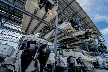 Speed motor boats are stapled in a garage system in the marina