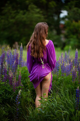 Vinnytsia, Ukraine. June 10, 2022. A girl in a purple dress in the summer in nature