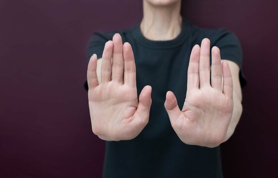 An Elderly Woman Stretched Out Both Hands With Open Palms, Showing A 