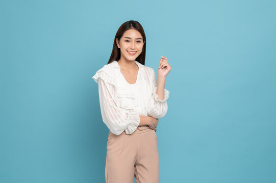 Young beautiful asian woman with smart casual cloth smiling isolated on blue background