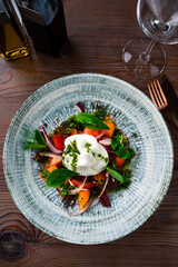 burrata Buffalo cheese served with fresh tomatoes and pesto sauce on plate