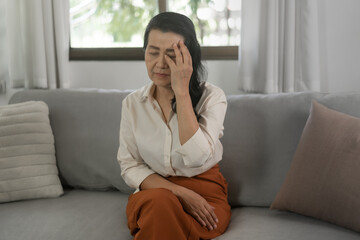 Obraz premium Happy and cheerful older lady Mature asian woman had Headache pain or sick health care concept