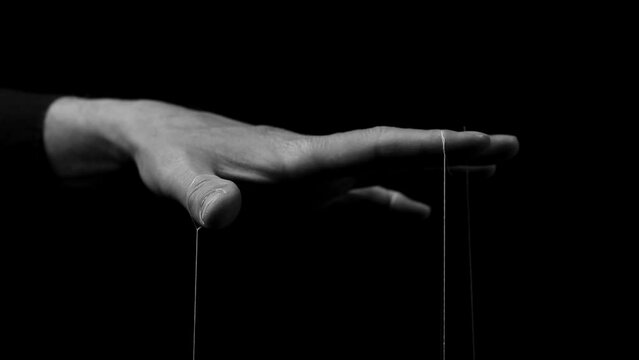 Boss hand manipulating, managing smth, moving fingers with strings. Master manipulation. Authority, dictatorship concept.