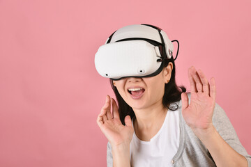 Asian woman using vr glasses, Watching movie and playing video games from virtual reality headset, Young woman amazed with new experience by vr technology, Studio shot.