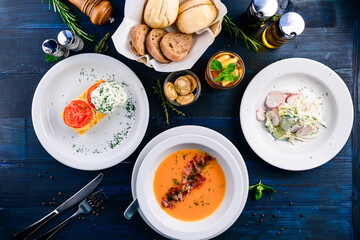 Top view of a three course set menu served on wooden table