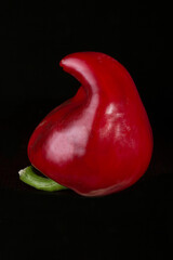 Red sweet pepper on a black background