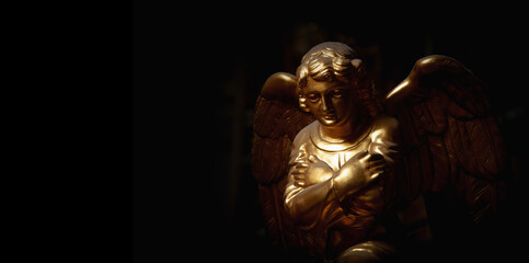 Fototapeta na wymiar Praying angel with arms across chest. Copy space.