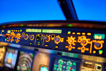 Illuminated Airbus A320 cockpit during cruise flight - obrazy, fototapety, plakaty