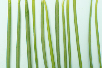 Fresh green onions on bright blue background. Healthy eating concept