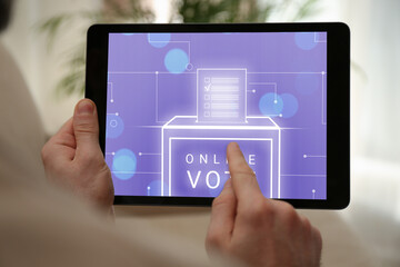 Man voting online via tablet indoors, closeup