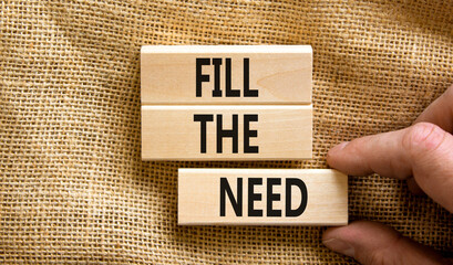 Fill the need symbol. Concept words Fill the need on wooden blocks on a beautiful canvas table...