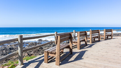 Obraz na płótnie Canvas Beach Chair Benches Blue Ocean Horizon Sea Blue Sky