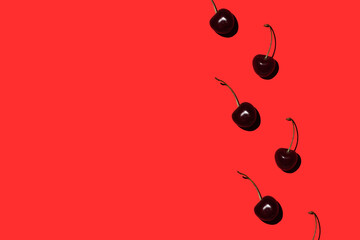 ripe cherry on a red background. Pattern