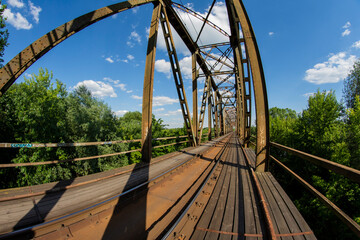 Railway viaduct in the UWA wide-angle lens on a sunny day. Summer.