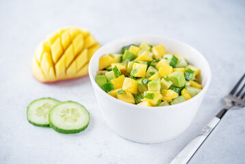 Mango avocado cucumber salad in a bowl
