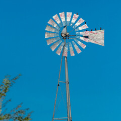 Birds sitting a windmill