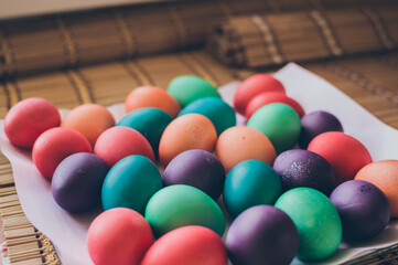 Fototapeta na wymiar Bright multicolored painted Easter eggs on white paper
