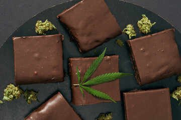 Chocolate cake and green marijuana leaf and buds