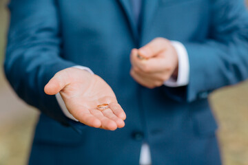 Fototapeta premium groom hands with rings