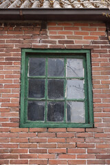 Old window with green frame in building outdoors