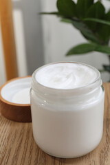 Obraz na płótnie Canvas Jar of hand cream on wooden table indoors