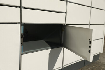 Modern parcel locker with open box, closeup view