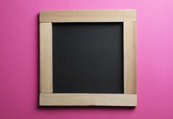 Blank chalkboard on pink background, top view. Space for text