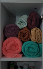 bright towels stacked in the closet
