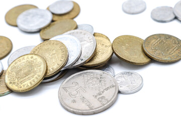 25 pesetas spanish old coins scattered on white background