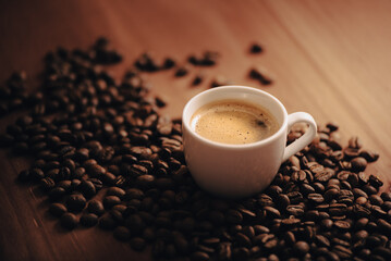 Taza de café, taza blanca, rodeado de granos de café, en mesa de madera, mesa de café, en la mañana