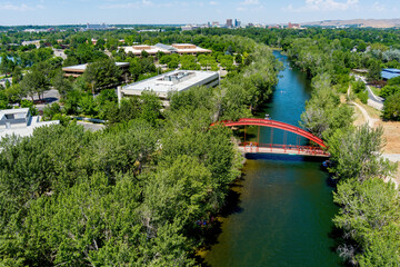 Iconic red bridge on the Boise River with floaters in the water