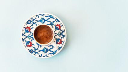Turkish coffee pot of coffee beans with coffee cup aon linen table