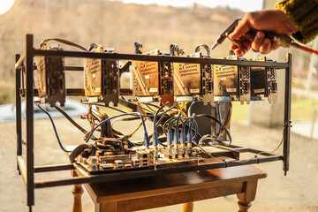 Man cleaning dust from cryptocurrency mining rig with air compressor