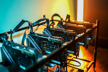 Close up of cryptocurrency mining rig and computer graphics