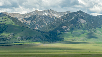 A vast, mountainous landscape under a cloudy sky in western Montana.
