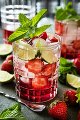 Fresh   drink with strawberry, lime  and  mint  leaves, selective focus