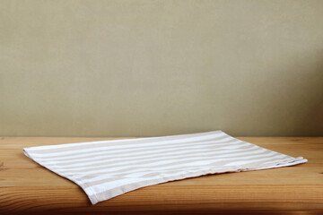 Empty wooden table with striped tablecloth.