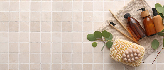 Set of bath accessories on beige background with space for text